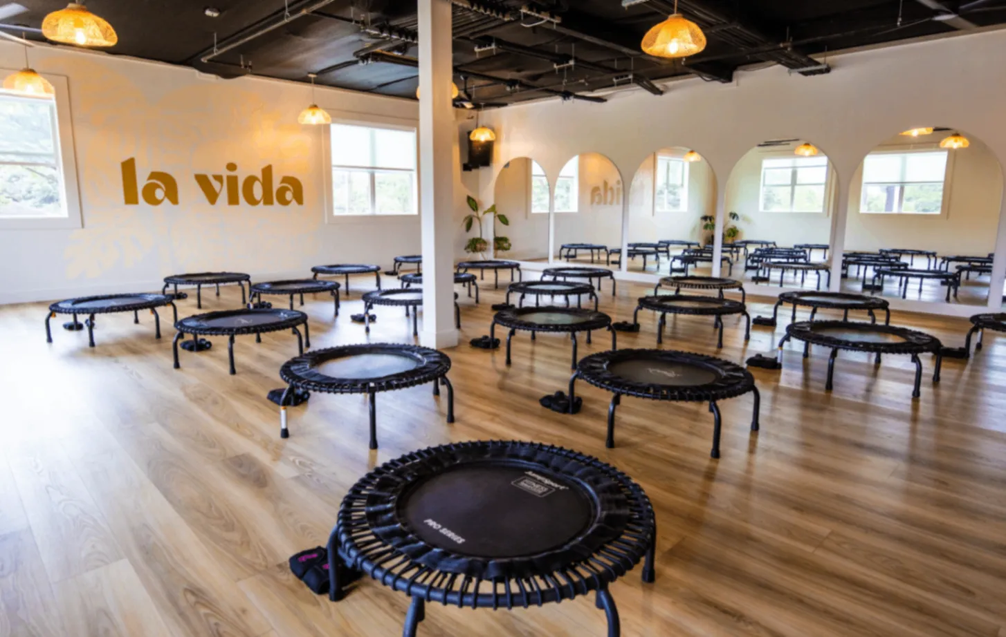 Bright La Vida studio set up with mini trampolines for a Bounce class